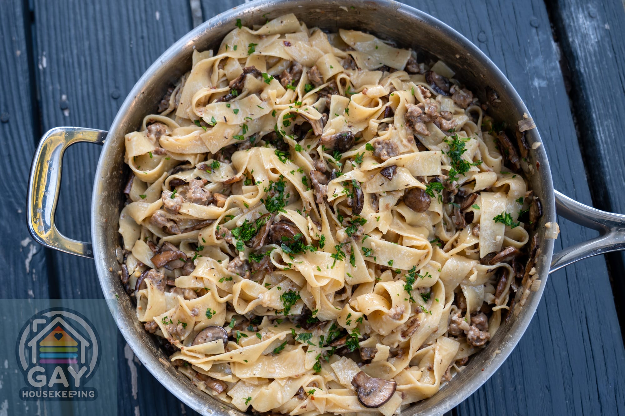 Overhead view of sausage and mushroom Marsala pasta in a stainless steel skillet