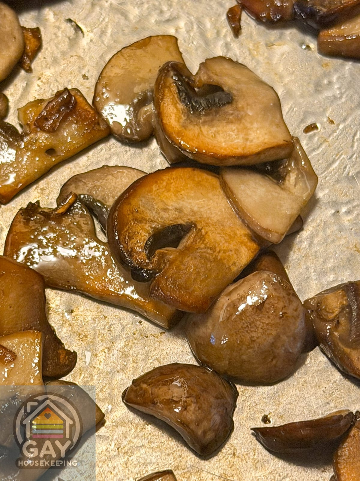 Deeply browned cremini mushrooms in a stainless steel skillet