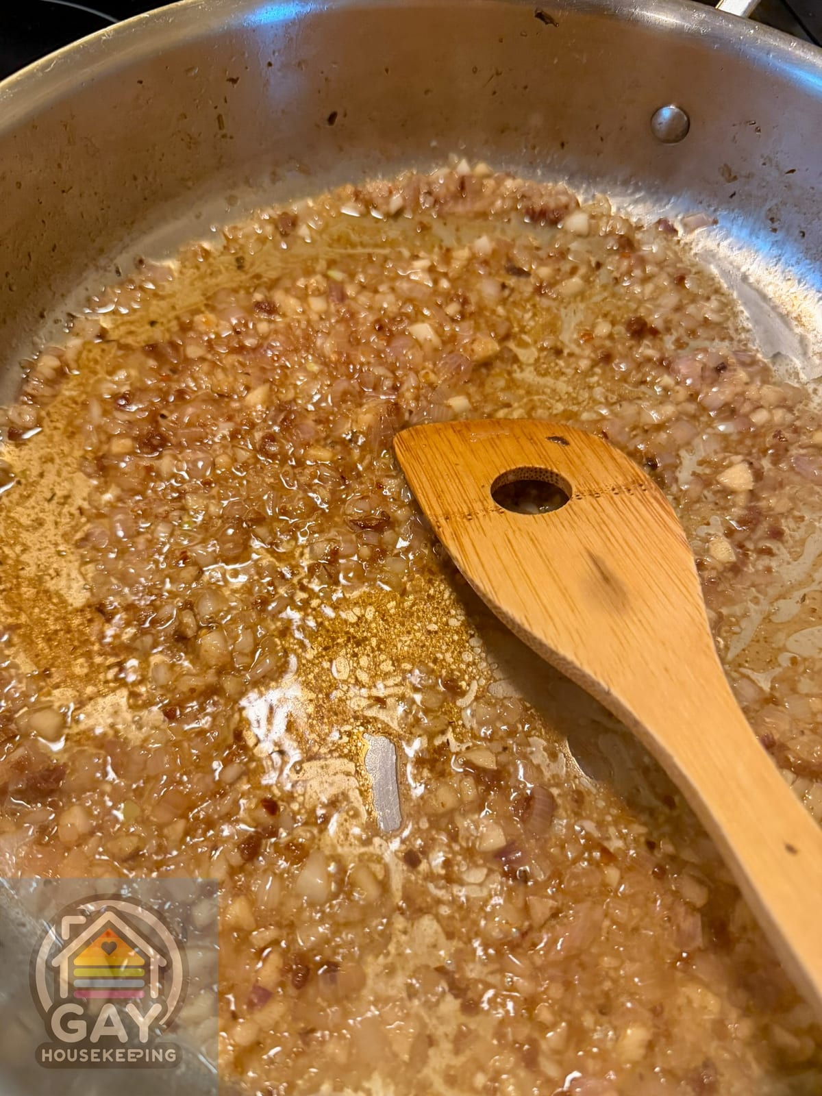 Marsala wine reducing with shallots in a stainless steel skillet